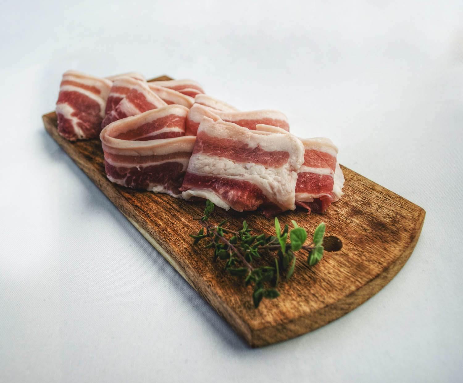 Sliced bacons on chopping board